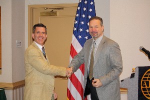 In November, Dr. Fred Wright (r), chief engineer, Cyber Technology and Information Security Laboratory, accepts an appreciation coin from Paul Reimers, chapter president.
